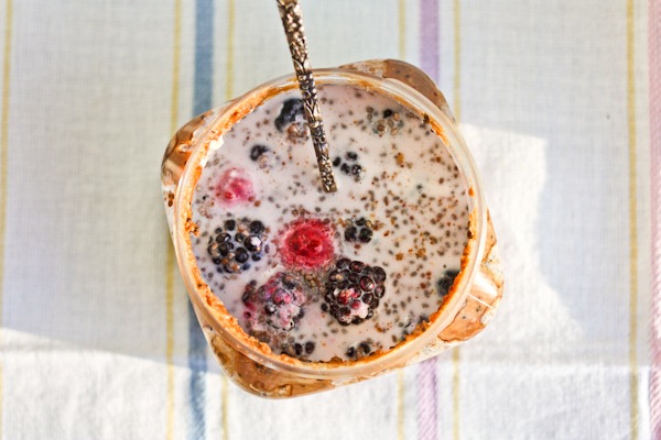 berry and oats in a nut butter jar