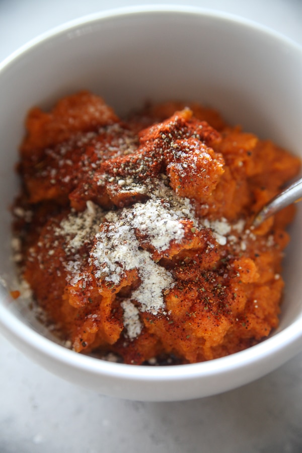 pumpkin with spices in a white mixing bowl
