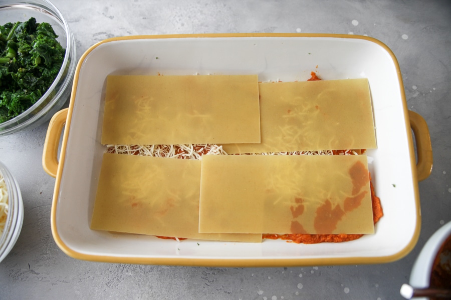 lasagna noodles on top of cheese and pumpkin