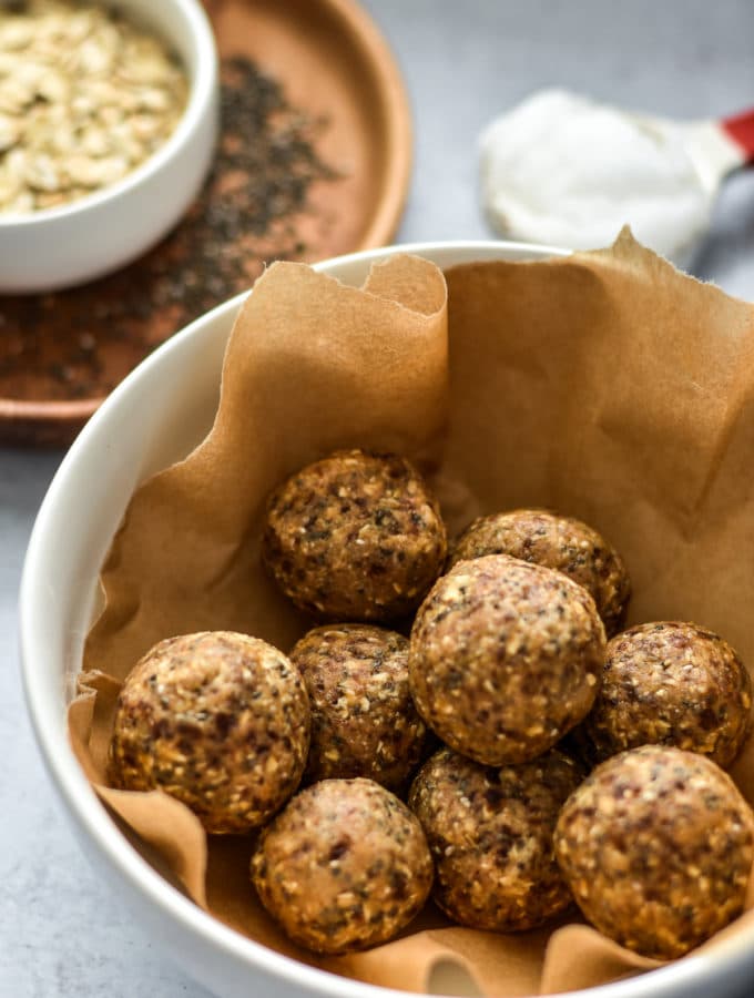 cookie dough balls in a container with brown paper