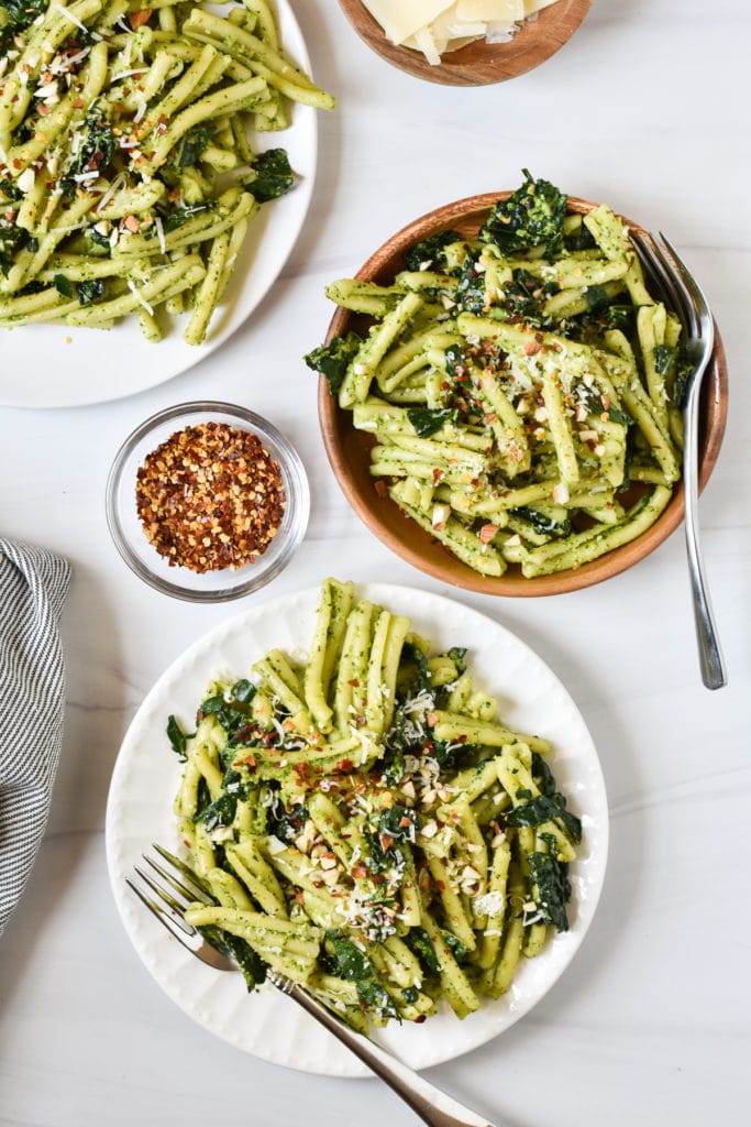 three small plates with pasta salad and red pepper flakes