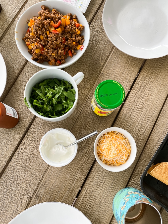 little bowls of ingredients for a family taco bar