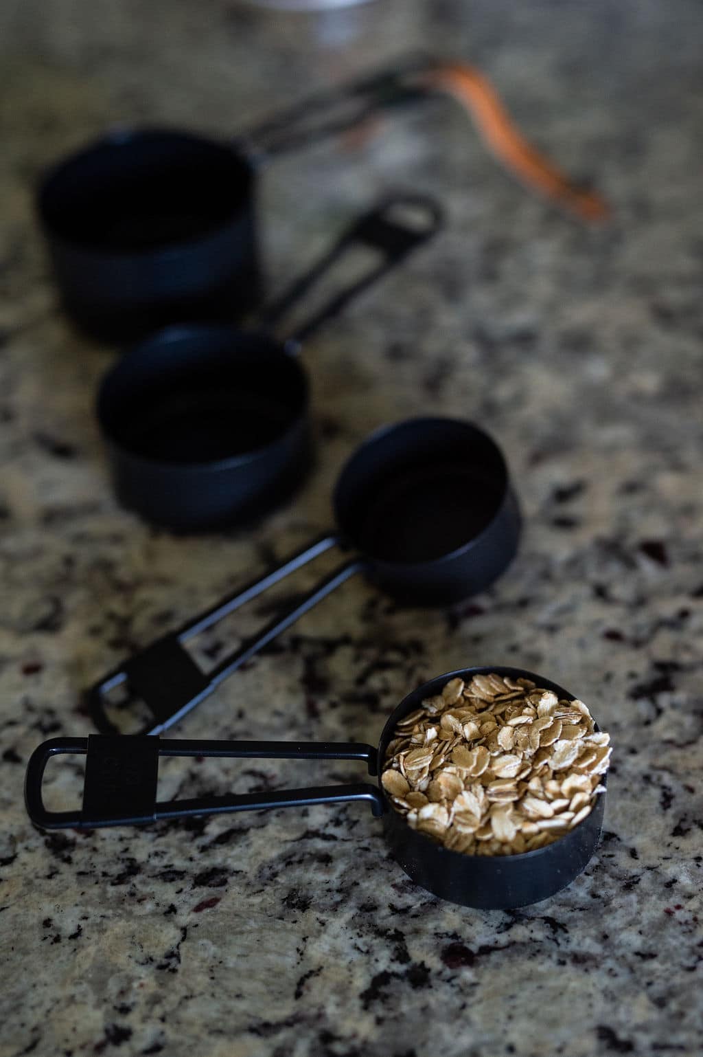 rolled oats in a black measuring cup
