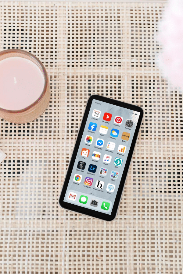 phone on wicker table with candle