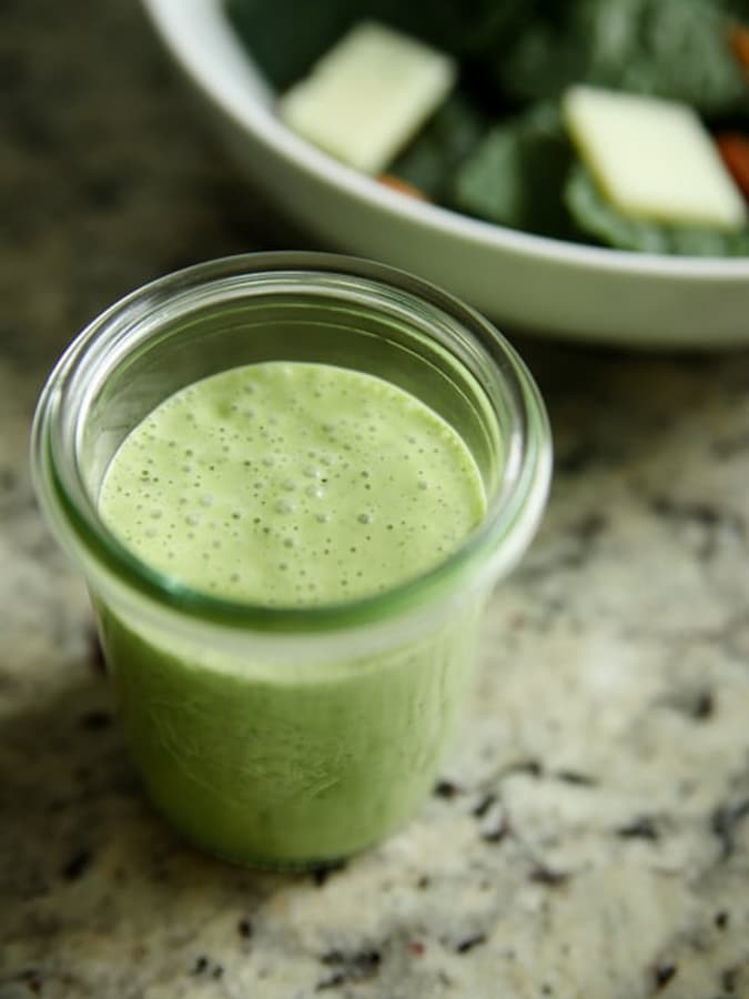 mini jar of green herb homemade salad dressing