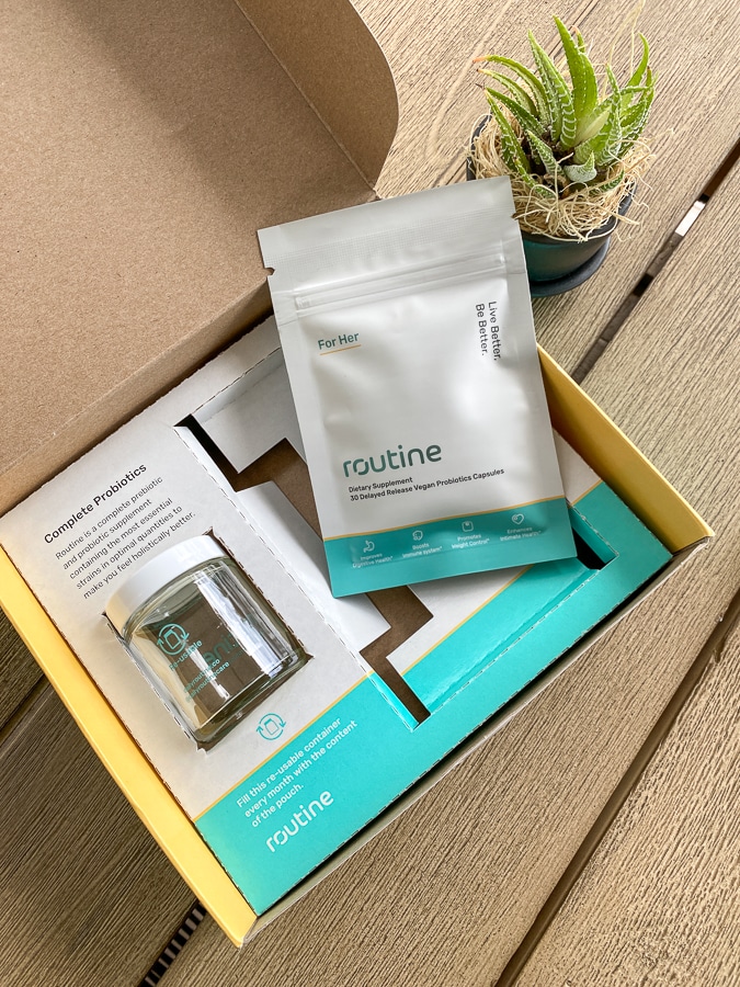 Routine box with empty glass jar and compostable pouch