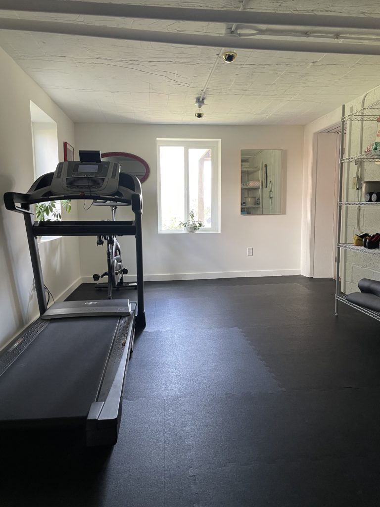 fitness room with treadmill and bike after