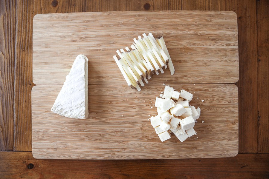 cheeses on a cutting board GIF