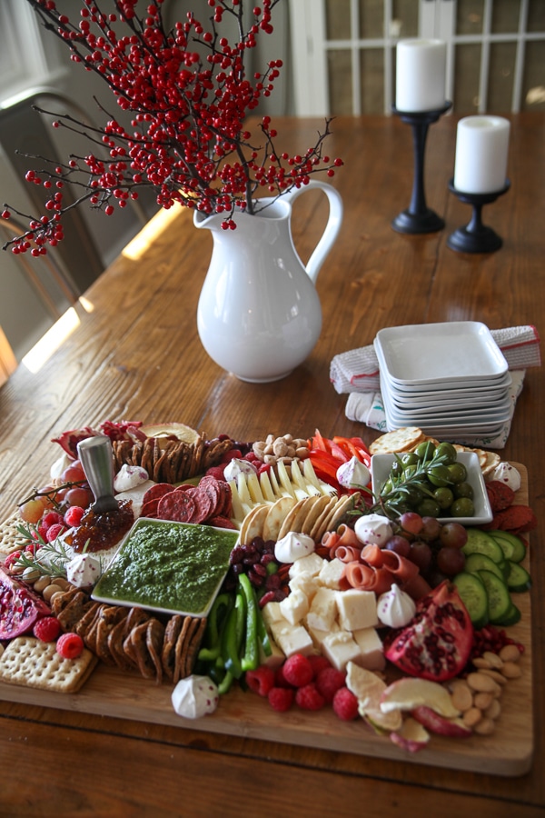 cheese board from above with pitcher, candles and plates
