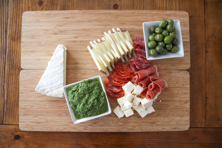 cheese, meats, and green olives with pesto dip