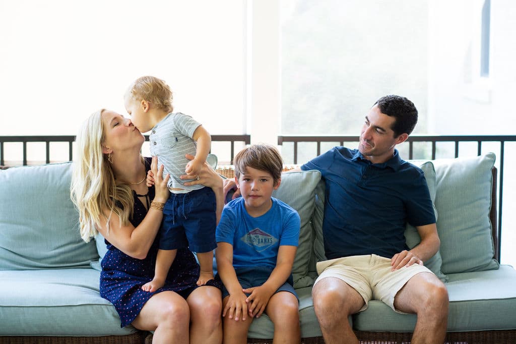Kath and family on a blue sofa