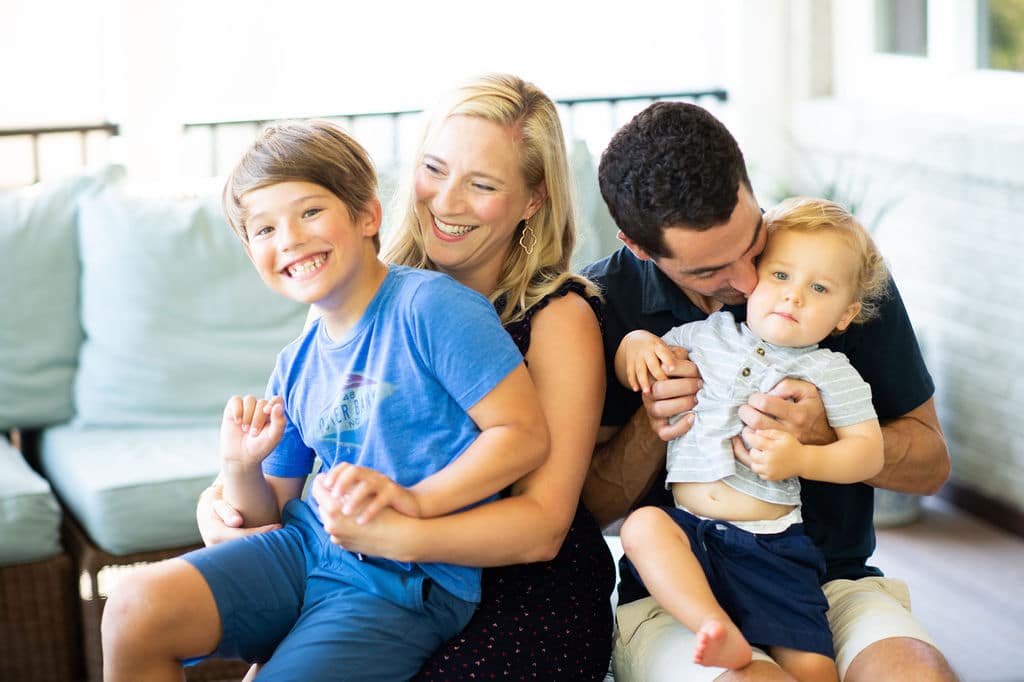 family on a couch laughing