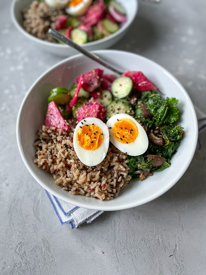 soft boiled egg dish on gray background in a white bowl