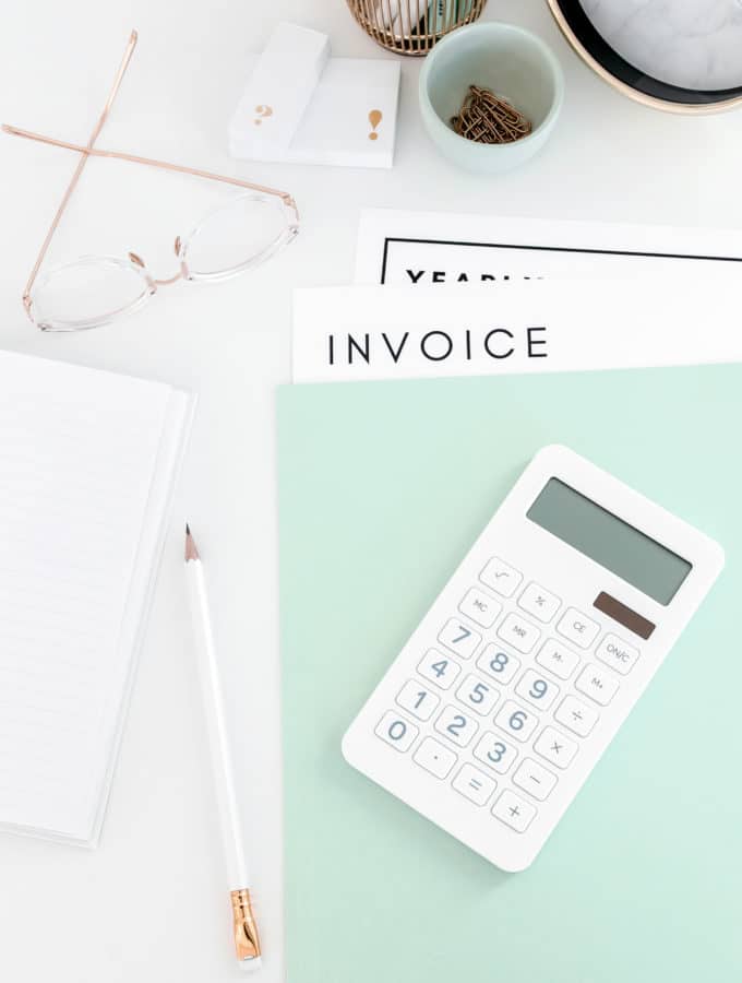 calculator and invoice on blue folder