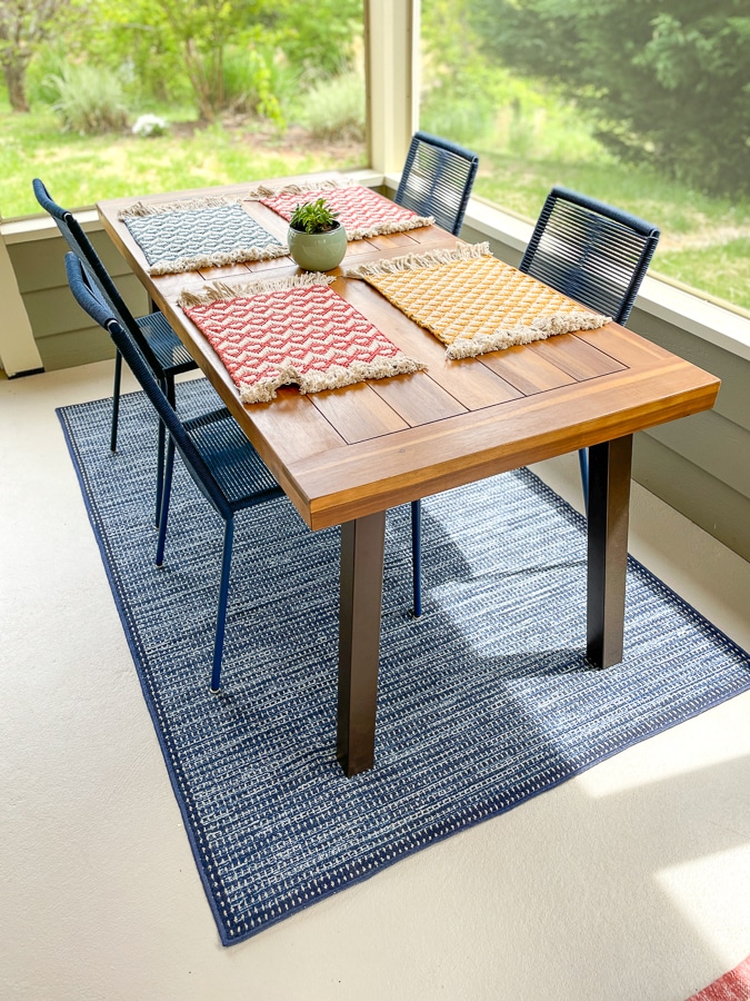 wayfair table with colorful placemats from the happy cook and navy blue rug