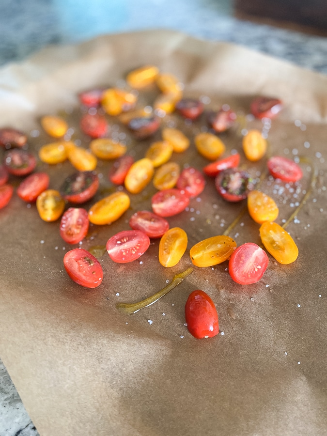 sliced cherry tomatoes sliced cherry tomatoes on parchment paper