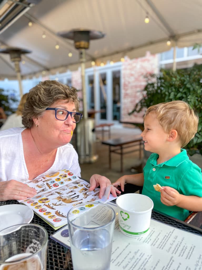 toddler giving stickers Birthday Dinner at Public | toddler giving stickers