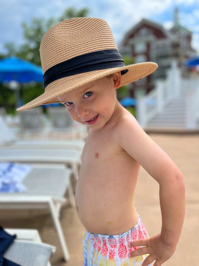 little boy posing with straw hat little boy posing with straw hat