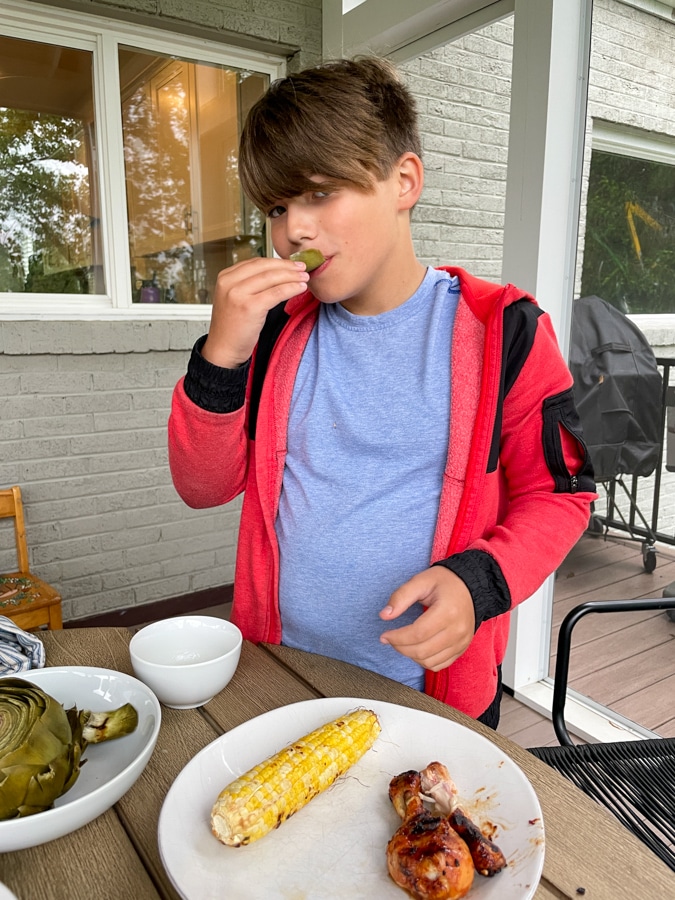Boy eating Artichoke Boy eating Artichoke