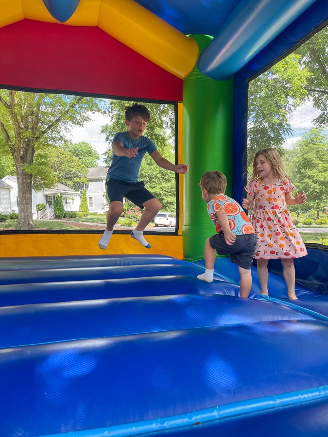 Cousins playing in bounce house