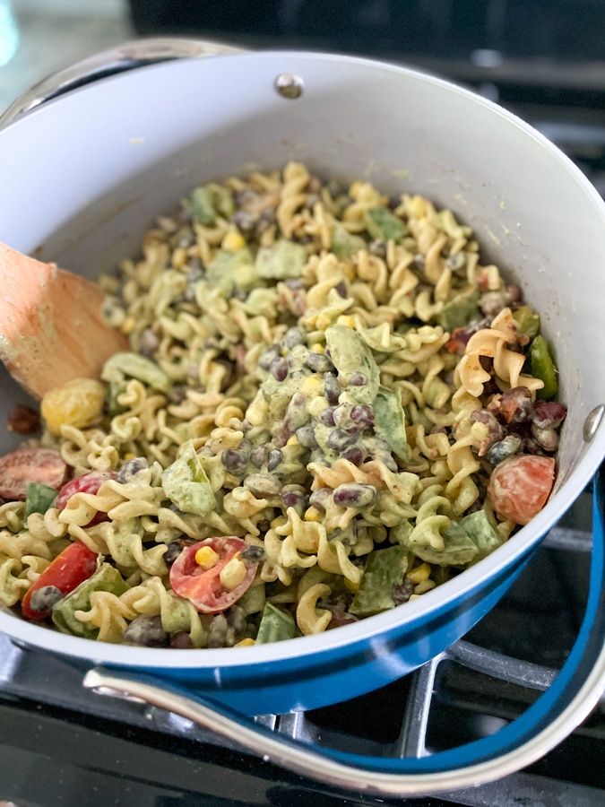 Pour dressing and tomatoes into pot Pour dressing and tomatoes into pot