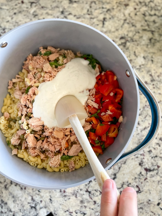 Stir dressing in pasta salad Stir dressing in pasta salad