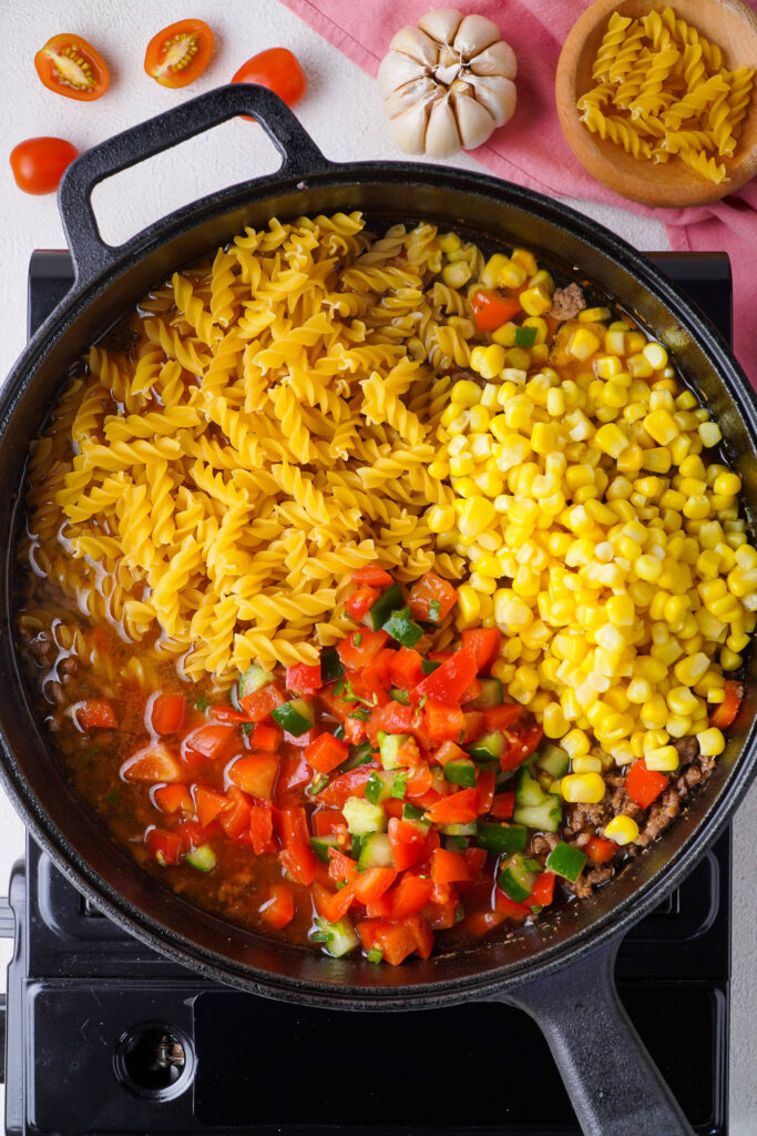 Add water pasta pico and corn Add water, pasta, pico, and corn