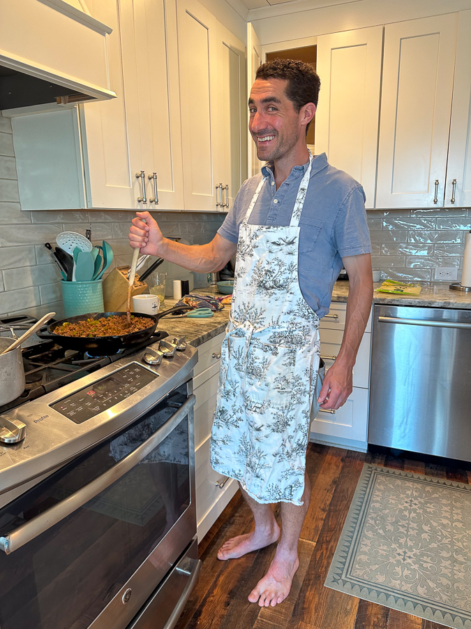 Thomas in apron cooking