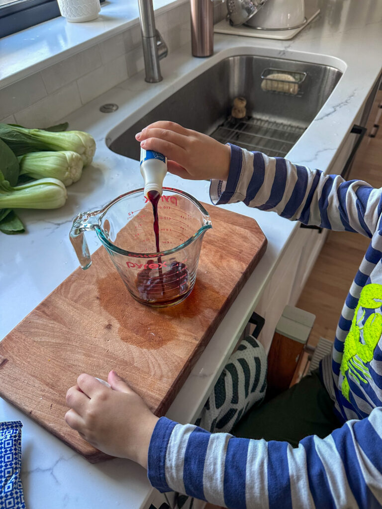kid making peanut butter sauce