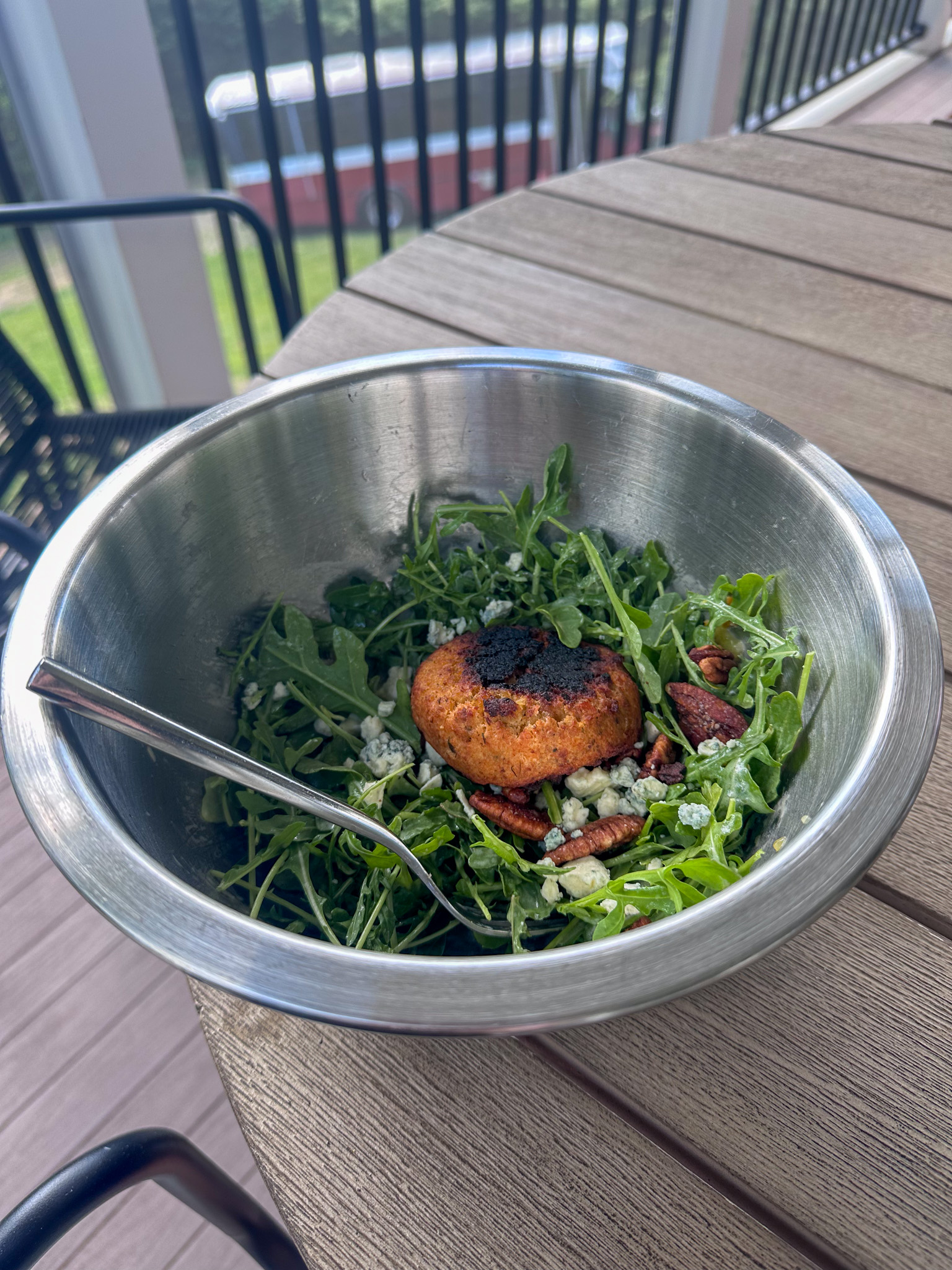 Salmon cake over arugula salad
