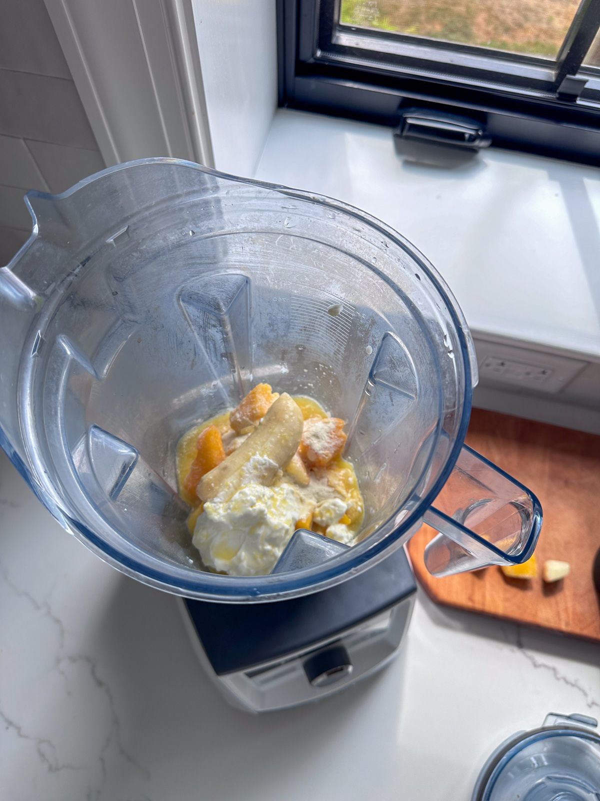 Smoothie ingredients in blender Mango Pineapple Smoothie ingredients in blender