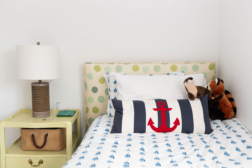 12 Summer Decorating Ideas: pillows and a stuffed to on a bed