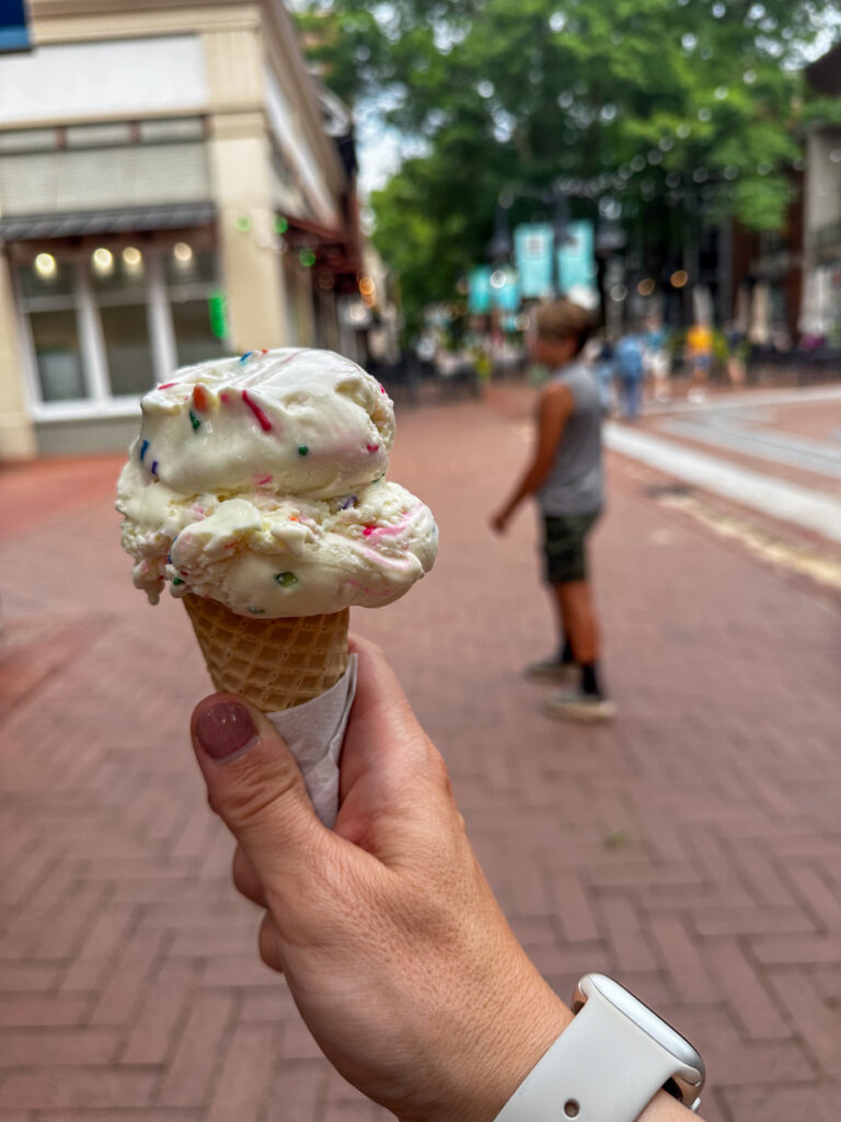 person holding a cone with ice cream person holding a cone with ice cream