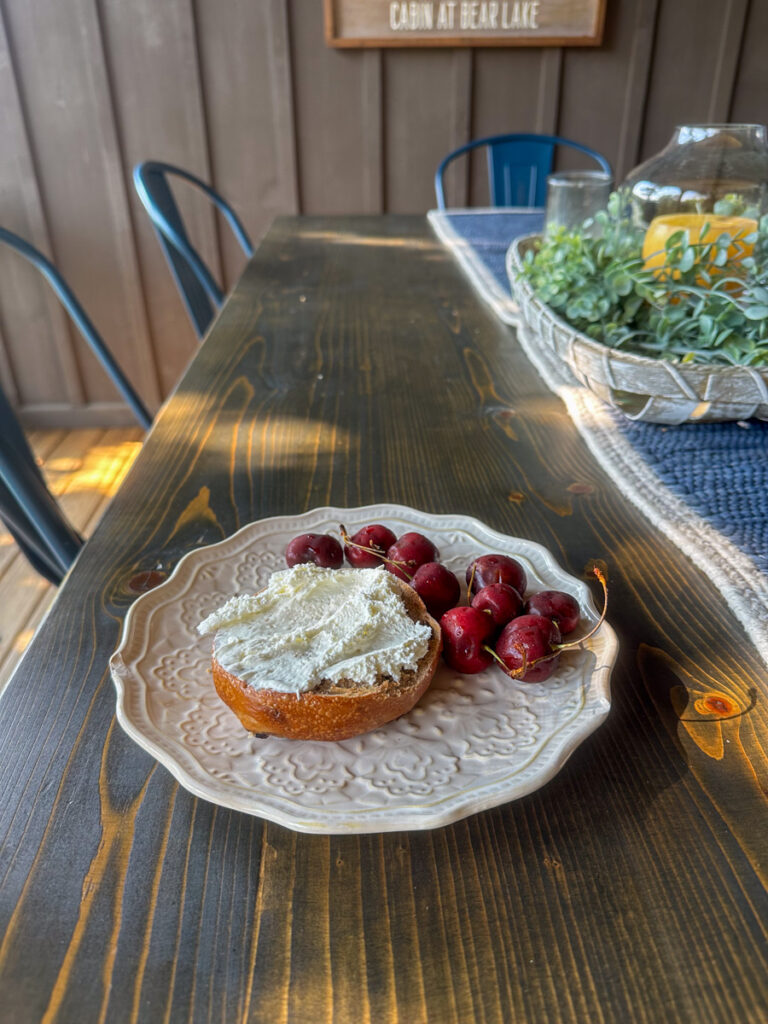 Kath Eats Blogger Kath Younger shares their Bear Lake Reserve vacation: in photo: berries and bagel on a plate
