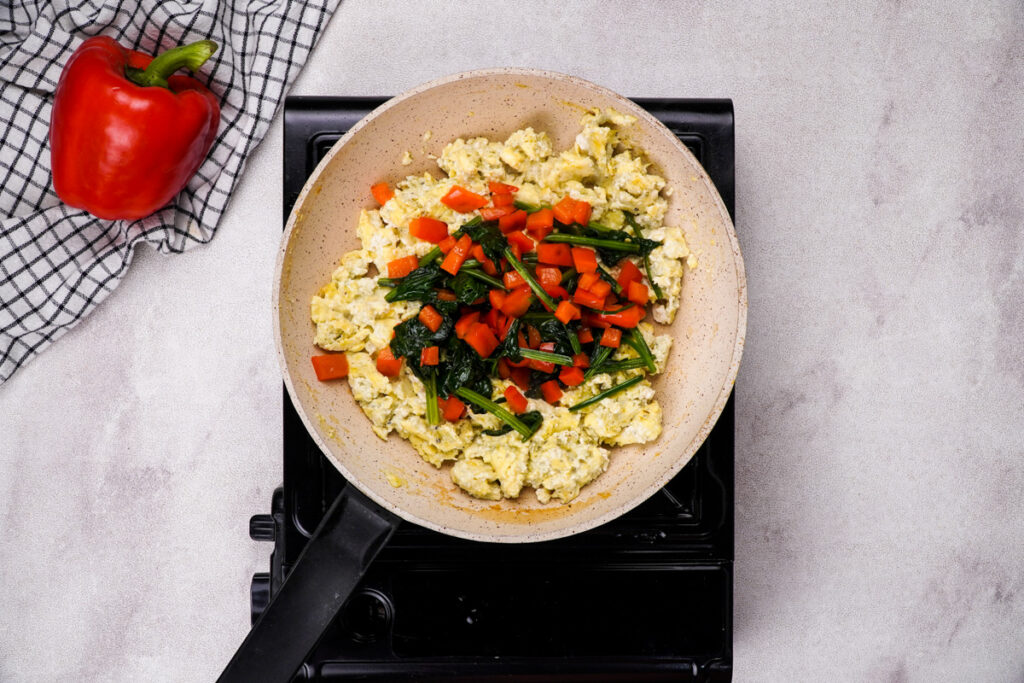 Add sautéed peppers and spinach